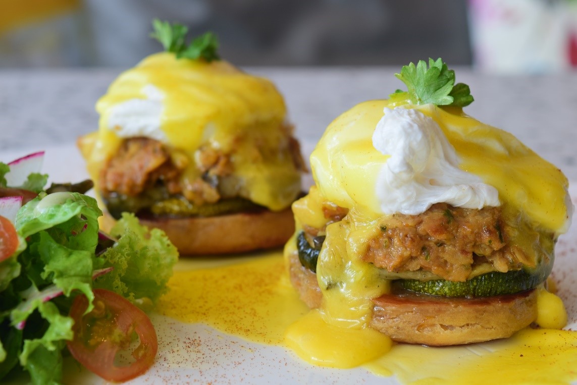 Two poach brown organic eggs, grilled eggplant, and chickpeas on a sundried English muffin topped with Hollandaise sauce, with salad on the side.
Veggie Benedict (P410)