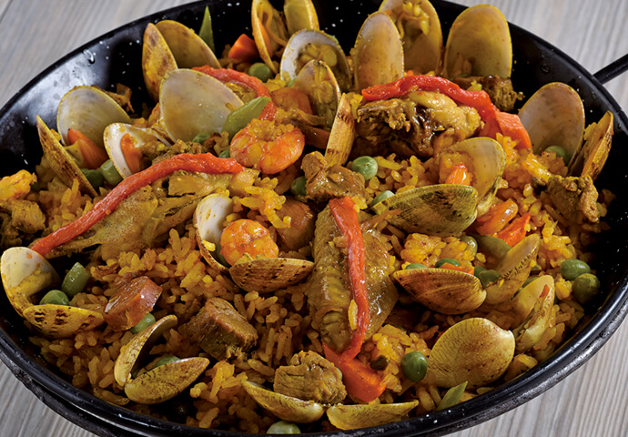 Paella Mixta - a traditional Spanish rice dish with meat, chicken, seafood, and chorizo